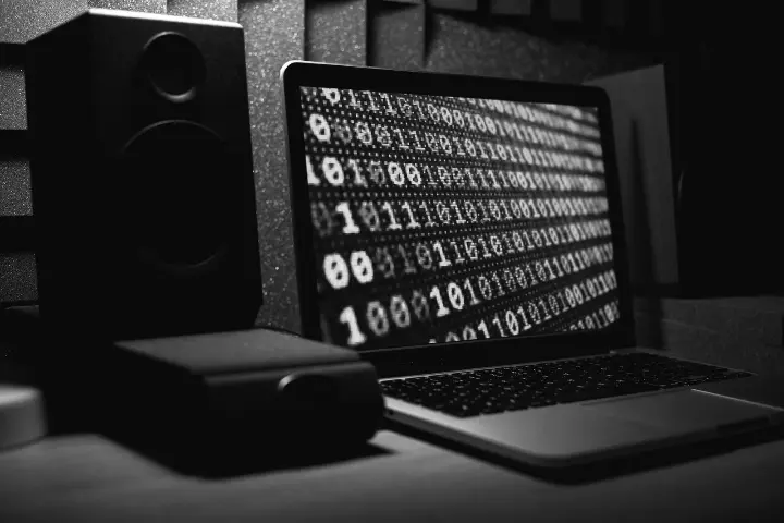 Mustavalkoinen kuva, missä on tietokone ja äänentoistojärjestelmä. Kuvituskuva.